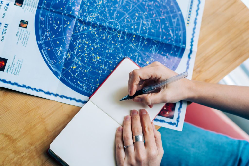 a person writing on a piece of paper