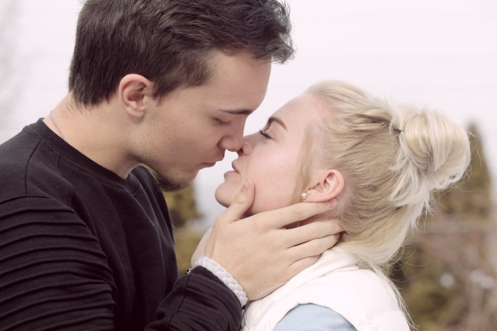 a man kissing a woman