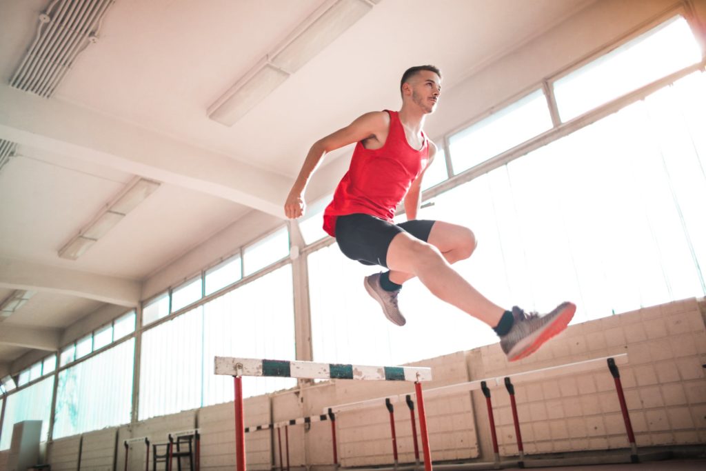 a man jumping off a wooden platform