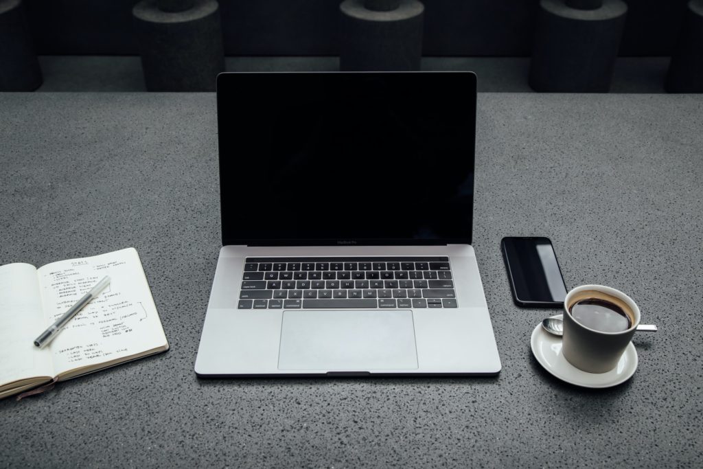a laptop and a cup of coffee on a table