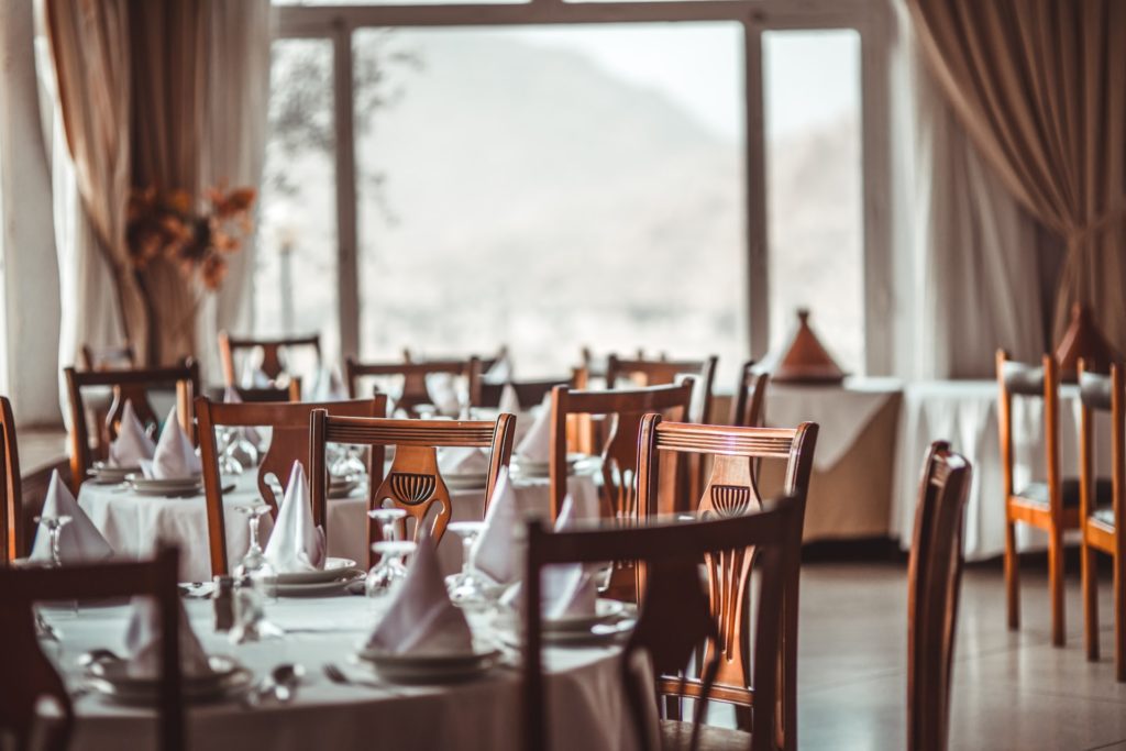 a table with chairs and a vase on it