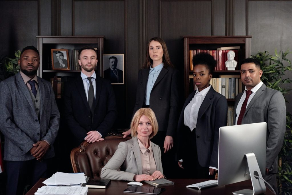 a group of people standing around a computer